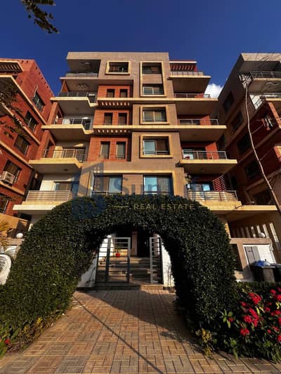 Apartment for sale in Al-Firdaws Compound, Al-Zuhur with an open view and double face garden, on the main street directly on Al-Wahat Road, minutes from Zewail Road, 6th October