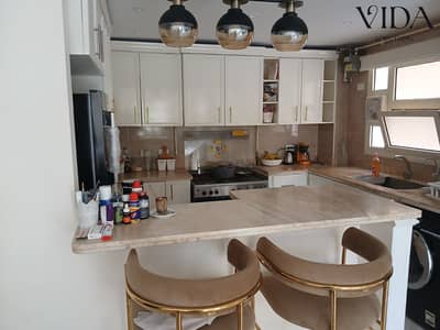 For sale in Al Khamayel, a very special double view ground floor apartment with a garden, fully furnished with the most luxurious furniture