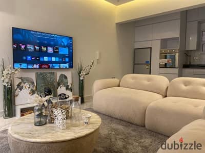 Studio for rent in Sheikh Zayed: ground floor with a garden, featuring hotel-style furnishing.
