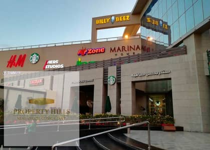 محل للبيع امام الجامعه الامريكيه هيدخل عائد 147,000 شهريا والسعر بالتقسيط علي 7 سنين في اقوي مول في التجمع الخامس