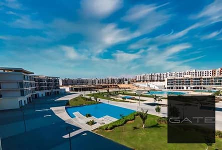 شقة بأقل سعر ريسيل للبيع في كمبوند نيوم 6 أكتوبر – التوسعات الشمالية فيو مباشر على حمام السباحة