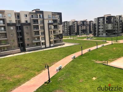For sale, an apartment of 130 meters on the first floor above ground, corner with a distinctive view in the Jannah Compound, 6 October