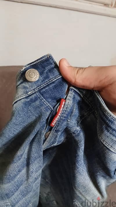 Blue light washed Dsquared2 denim jeans feature porminet heavy ripping