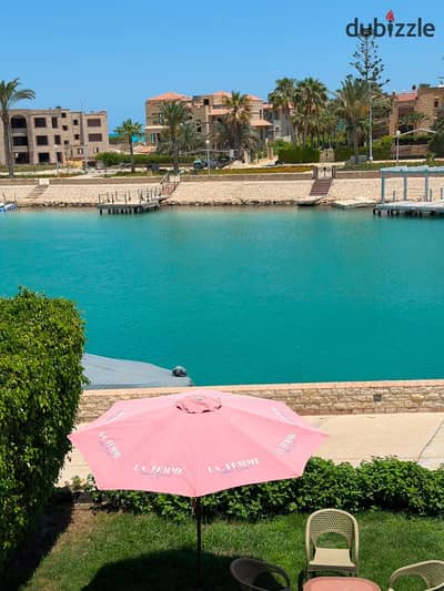 For rent: a villa in Marina 5, first row by a rocky beach.