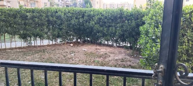 Apartment for sale in District 12, Sheikh Zayed (Al-Mustaqbal Buildings). It is a ground-floor unit featuring a private garden, and includes the kitchen and chandeliers. It boasts a prime location and a wonderful view.