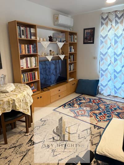 Studio apartment for sale in the new Phase 7 of Al Rehab 2, fully furnished and equipped, with a wide garden view, next to the Eastern Market and serv