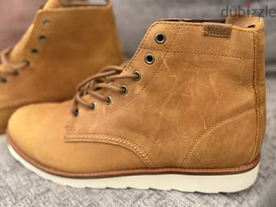 Vans leather high-top work boots in a tan/honey-brown oiled leather fi