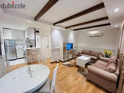Furnished studio for rent on the ground floor with a garden view, wide garden, modern furniture, and air conditioning.