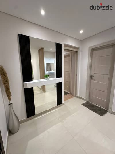 2 Bedroom apartment with a stunning double view 12-year installments or huge discount, on Suez Road minutes from AUC near Madinaty The Spine Tower