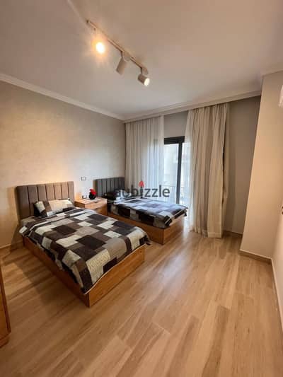 Furnished apartment with two bedrooms and a maid's room for rent in Eastown Sodic Compound - New Cairo