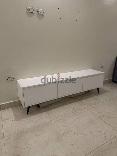 TV table. Three drawers all white with black legs.