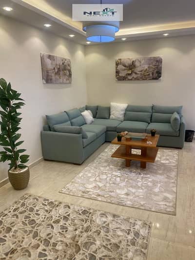 For rent in Madinaty: a 135m² apartment featuring modern furnishings and full air conditioning. It boasts a prime location, very close to the Open Air