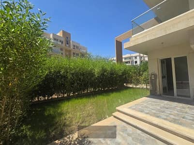 For rent, a distinguished ground-floor apartment with a private garden, ultra-super lux finishing, kitchen, and air conditioning inside | Mountain View iCity - 6 October