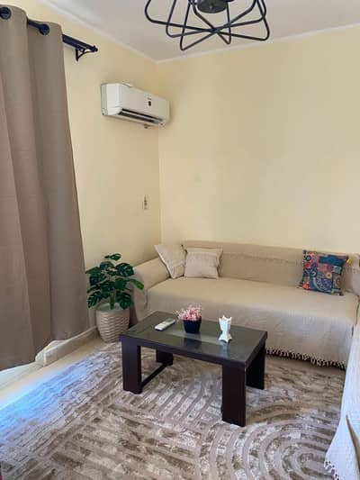 Furnished apartment for rent in the Al-Mostaqbal complex, Sheikh Zayed; includes kitchen and air conditioning, featuring a prime location and a view