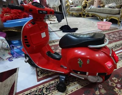 Vespa-style electric ride-on scooter for kids