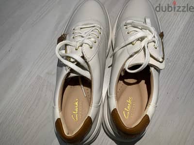 Clarks Women's Un Rio Zip sneaker in White Leather