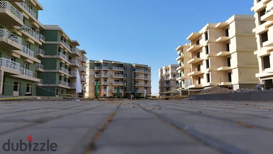 Ground floor apartment with a large garden for sale in Green 6 Compound, Idris Buildings. Installment payments available at a special price.