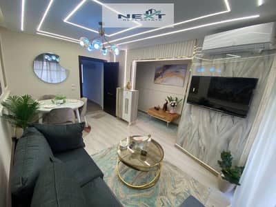 For rent in Madinaty, a furnished apartment of 70 sq m, 2 bedrooms + 1 bathroom, third floor, special finishes, hotel-style furnishings, open view, mi