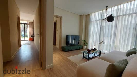 Apartment with a private garden in O West by Orascom, next to Media Production City