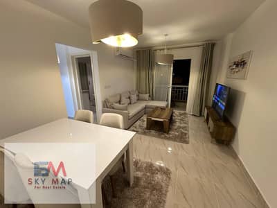 For rent in Madinaty (B12): A fully furnished, 85-square-meter apartment featuring ultra-super-lux finishes and hotel-style furnishings. The unit is f
