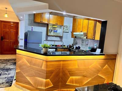 For rent: a furnished apartment in Sheikh Zayed, a prime location next to the malls.