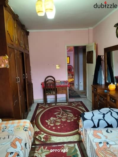Apartment for sale on the eighth floor with an elevator, consisting of two bedrooms, a bathroom, a kitchen, a reception area, and a roof from inside the apartment on 105 Street, Maadi