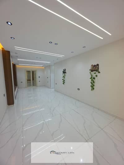For sale in Al-Ahram Gardens, a 140 m² ground floor apartment with a garden, ultra-super lux finishing, steps to the gate