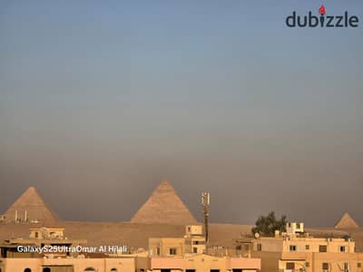 145m overlooks next to the gate view of the Pyramids