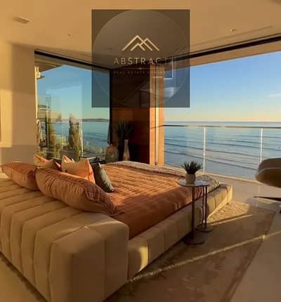 With a panoramic sea view, fully furnished + appliances + kitchen + air conditioners for sale in Marina 5, Lisan Alwuzara, North Coast, next to Rixos,