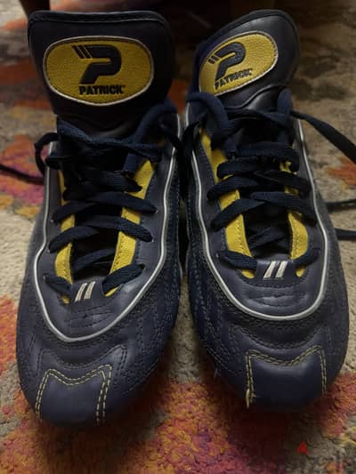 This is an original Patrick Super Cup FG in navy/white/yellow, size 42