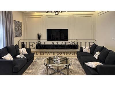 Fully finished Ground-floor apartment with a private garden featuring a prime location and direct landscape view includes a kitchen equipped