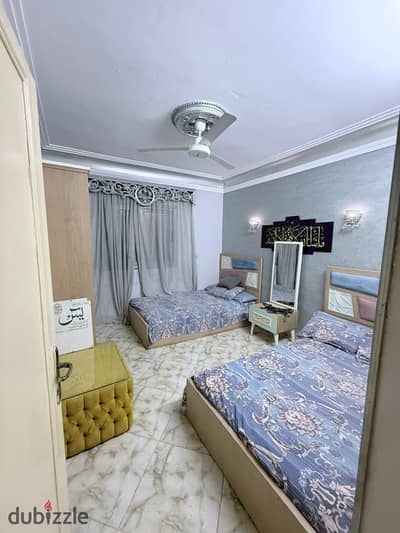 Furnished apartment for rent in Maadi Old, Street 106, behind the Al-Khalifa building, near the Metro station, Maadi Gardens. It has air conditioning, Wi-Fi, natural gas, and a balcony. It consists of two bedrooms, a reception area, a bathroom, and a kitchen on the second floor.