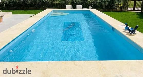For rent, a luxury model J villa in Madinty with a swimming pool and a garden view.