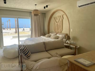 Two-bedroom chalet with a garden, first row on Lagoon, fully finished with air conditioning, for sale in Ras Al-Hekma, North Coast, near cities close to Mountain View La Vista