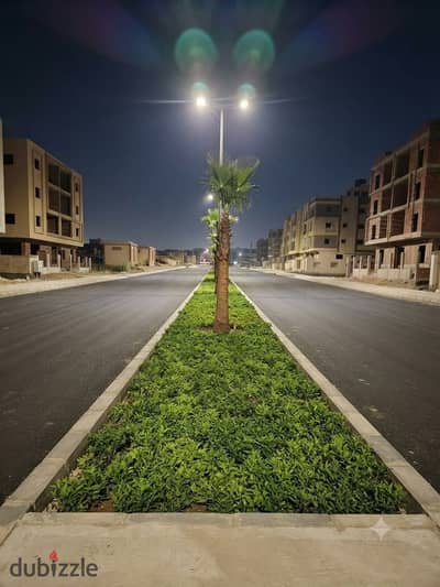 Land for sale directly on Suez Road – true north-facing – fully paid off – Beit Al-Watan – Fifth Settlement.