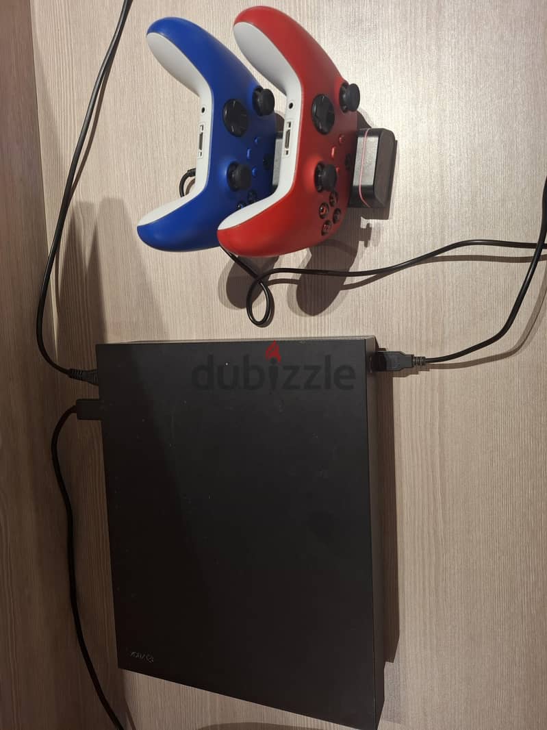 xbox one x with 2 series x controllers 1