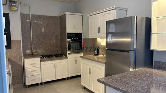 Apartment for rent in SODIC with a full kitchen equipped with appliances, air conditioning, and lighting
