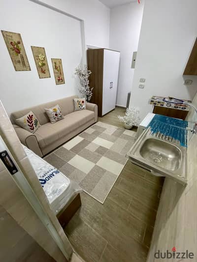Luxury hotel-furnished studio for long-term rent directly facing North 90th Street & Patio Mall in South Academy (Zone C), near CFC, Cairo Airport, & Banking District in New Cairo!