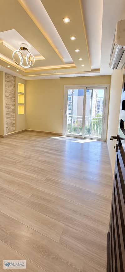 Unfurnished 190 sqm apartment for rent in the Amorada Compound, Fifth Settlement. Includes kitchen, air conditioning units, and appliances.