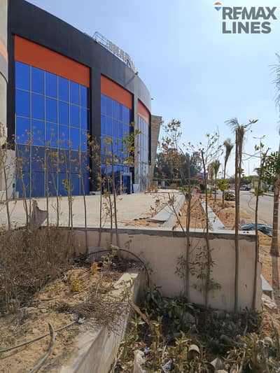 Commercial shop with a frontage on a main street of 115 meters + external area in Al-Shorouk City, Villas Area