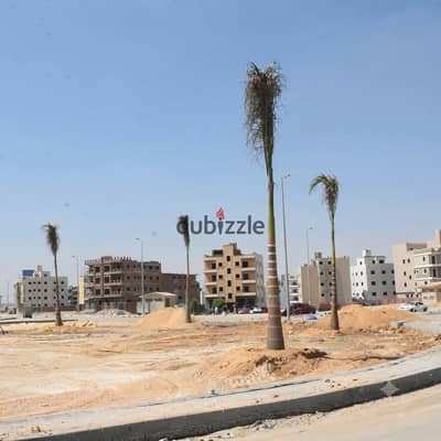 Land for sale: Frontage on a 32-meter wide separation strip, just steps away from the "View Zone" in the Fifth District (Hay Al-Watan), Fifth Settleme Land for sale: Frontage on a 32-meter wide separation strip, just steps away from the "View Zone" in the Fifth District (Hay Al-Watan), Fifth Settleme