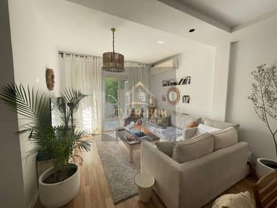 Ground-floor apartment with a garden for rent in The Address compound; 140 sqm, 3 bedrooms, includes kitchen and air conditioning units only.