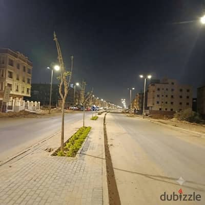Land for sale—fully paid off—featuring a street-facing location near the main road in the Beit Al-Watan district, Fifth Settlement, New Cairo.