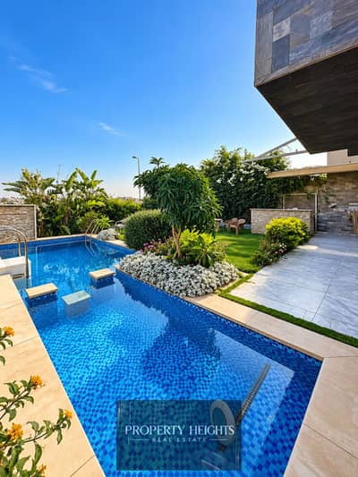 Spacious twin house in a prime location in Al Karma 4, featuring a private swimming pool and comfortable living spaces.