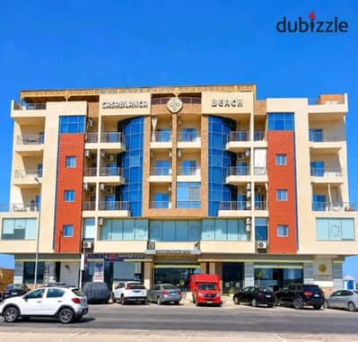 Apartment for sale (55 sqm) at Casablanca Beach Resort in the Al-Ahyaa district. Features include a bedroom, a living room, a private beach, swimming
