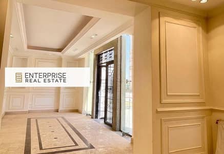 -Apartment style Villa ready to move in, fully finished with ACs and a private garden, in an Italian-style compound in New Cairo, with an iconic tower