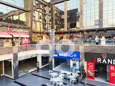 فرصة استثمارية وتجارية مميزة في مدينة الشروق على طريق الشباب مباشرة | محل أرضي 75م + 45م أوت دور تشطيب كامل واجهة على البلاز