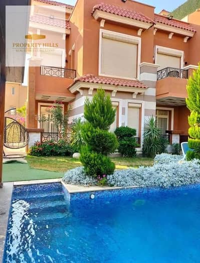 Villa for sale in a prime location, vibrant seaside setting overlooking landscaped areas and green spaces.