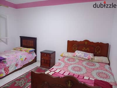 Furnished apartment for annual rent for a family or groom or student or company 2 bedrooms reception two pieces kitchen 2 bathrooms fifth upper floor all facilities available water electricity and elevator in Alexandria Al-Ajmi kilometer 21 at Al-Nakheel beach in a very special location