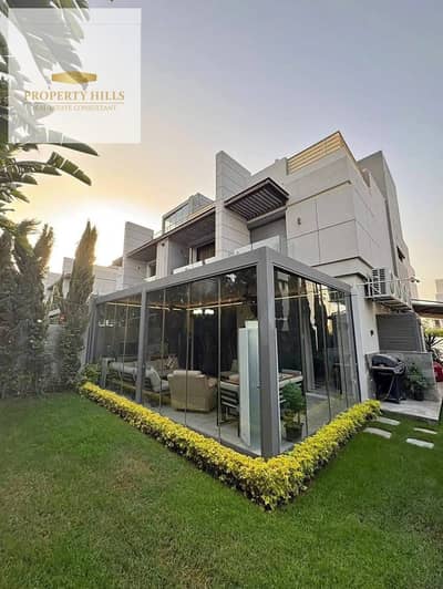 Villa for sale overlooking a landscaped area in a prime location in New Cairo.